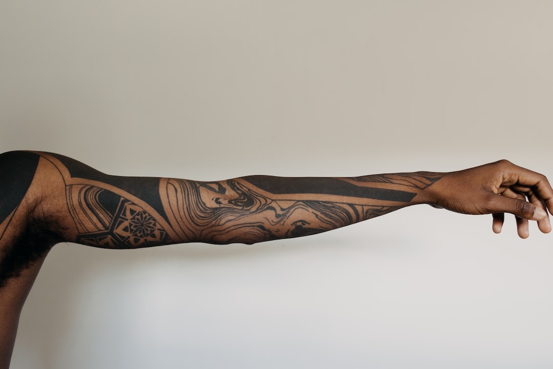 Tattooed arm on white background.
